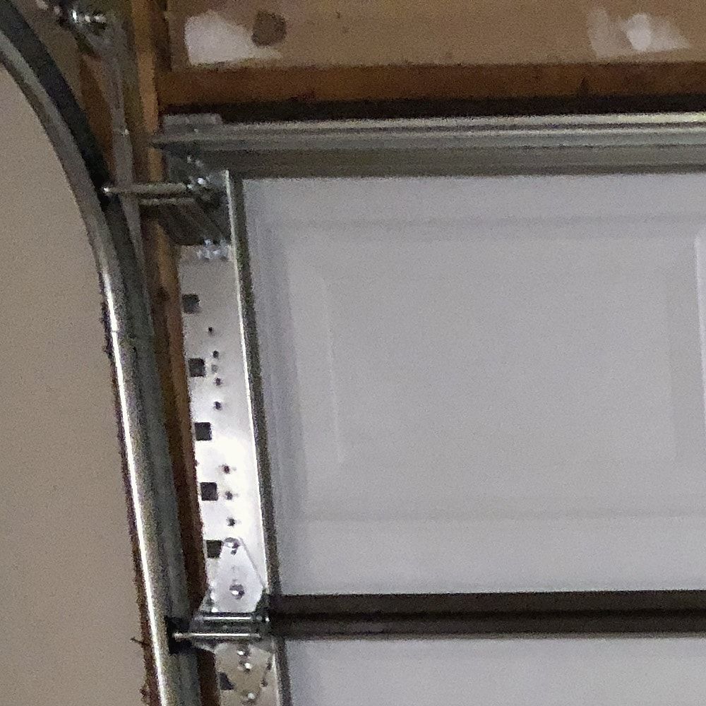 A garage door roller bracket, hinge plate and curved track