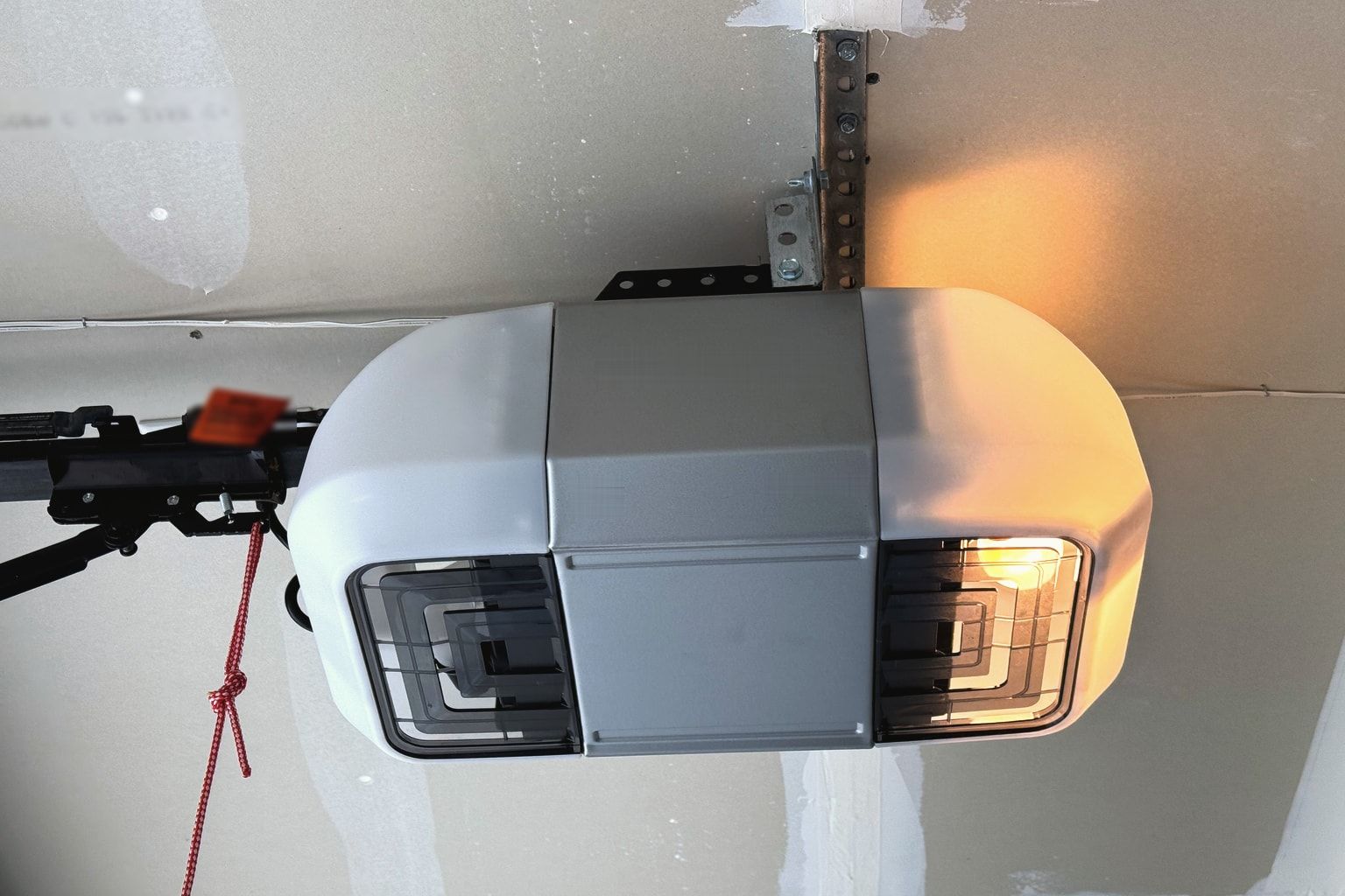 A garage door opener motor on a ceiling