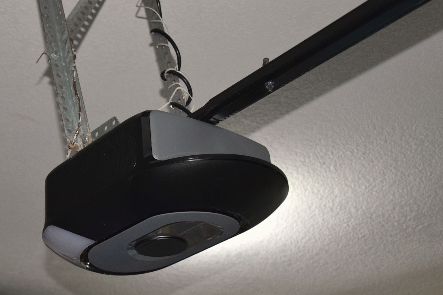 A garage door opener with its rail and hangers